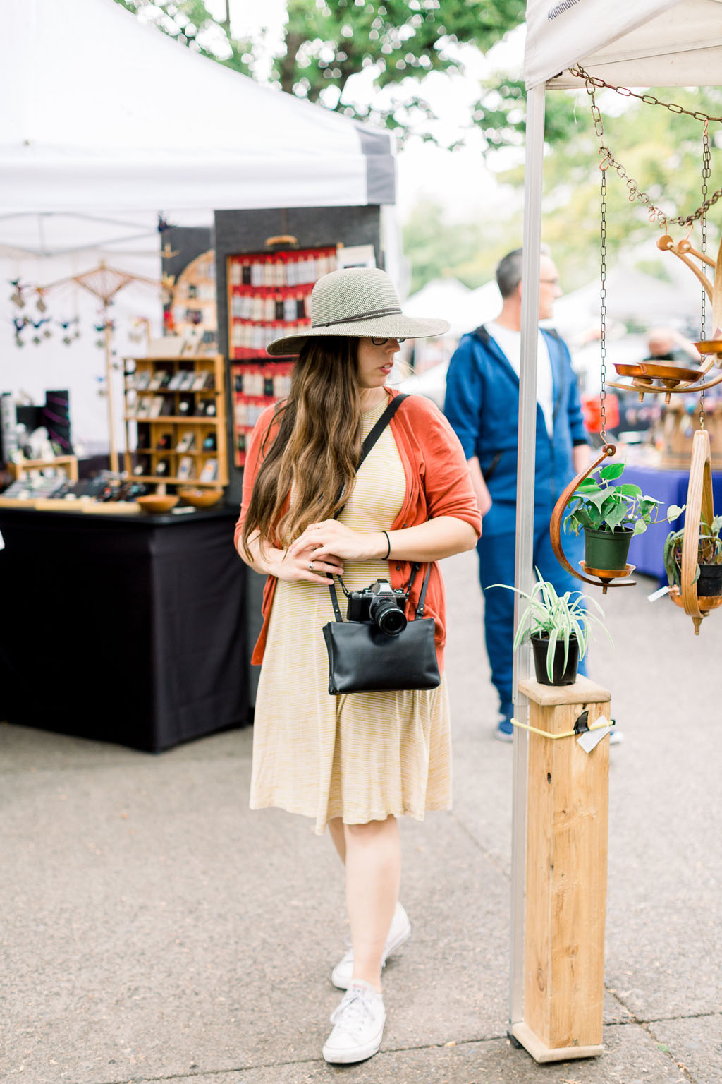 woman walking through the Eugene Saturday Market, one of the most fun things to do in Eugene, Oregon