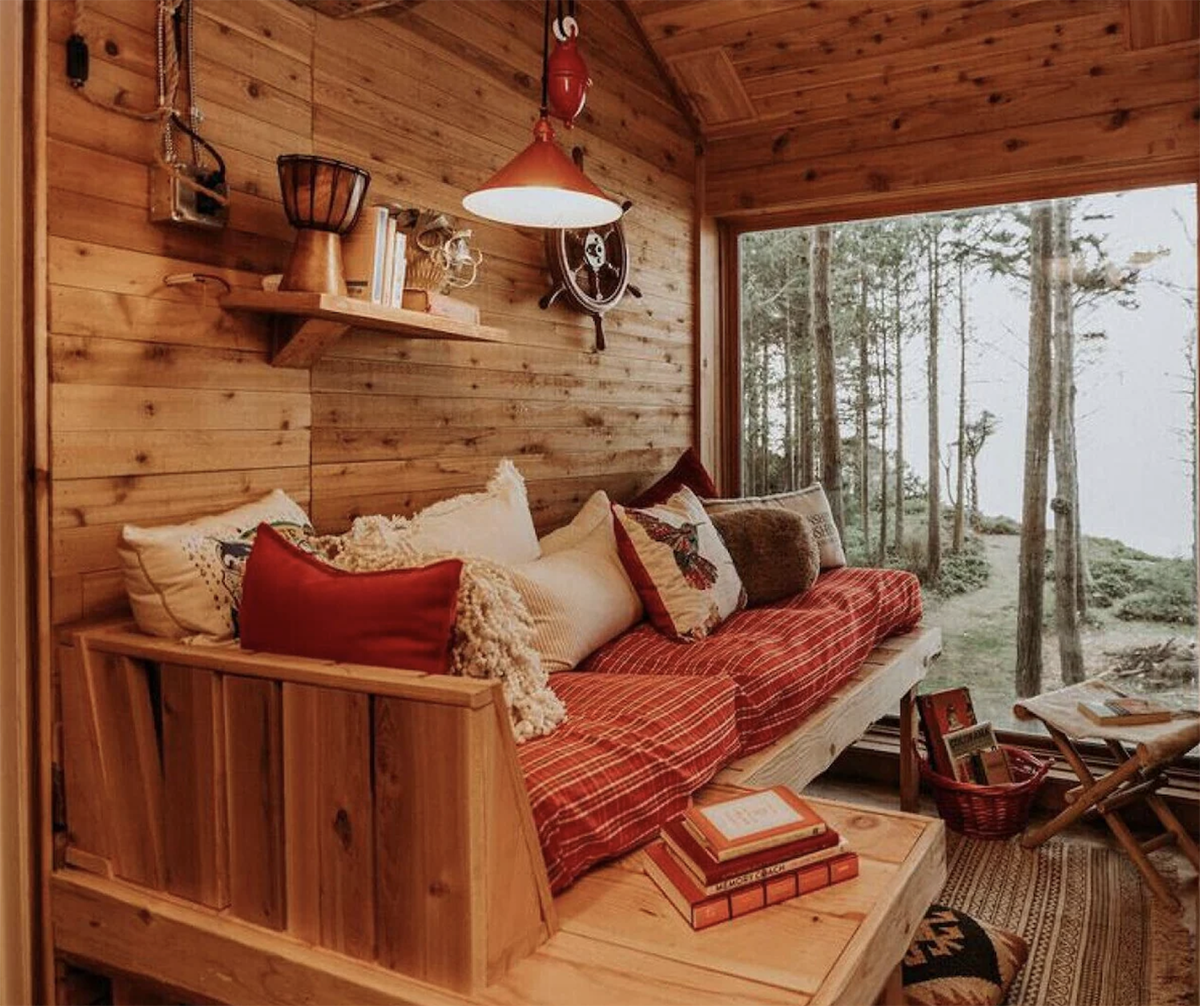 Rustic bench seating in front of a window overlooking the water