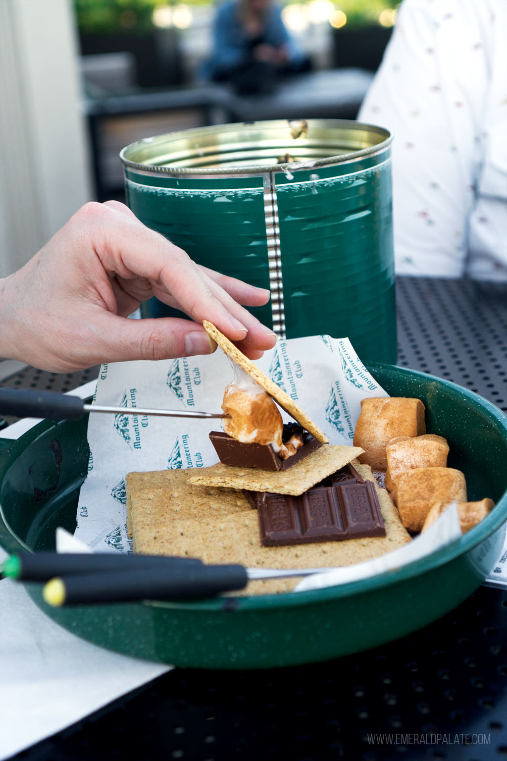 person putting a marshmallow on a s'more | RIY s'mores dessert 