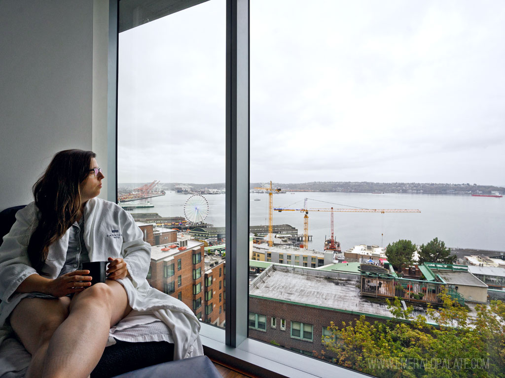 woman drinking coffee in a robe from one of the cool places to stay in Seattle