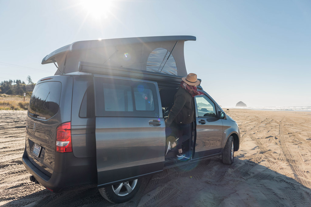 woman glamping in van in PNW