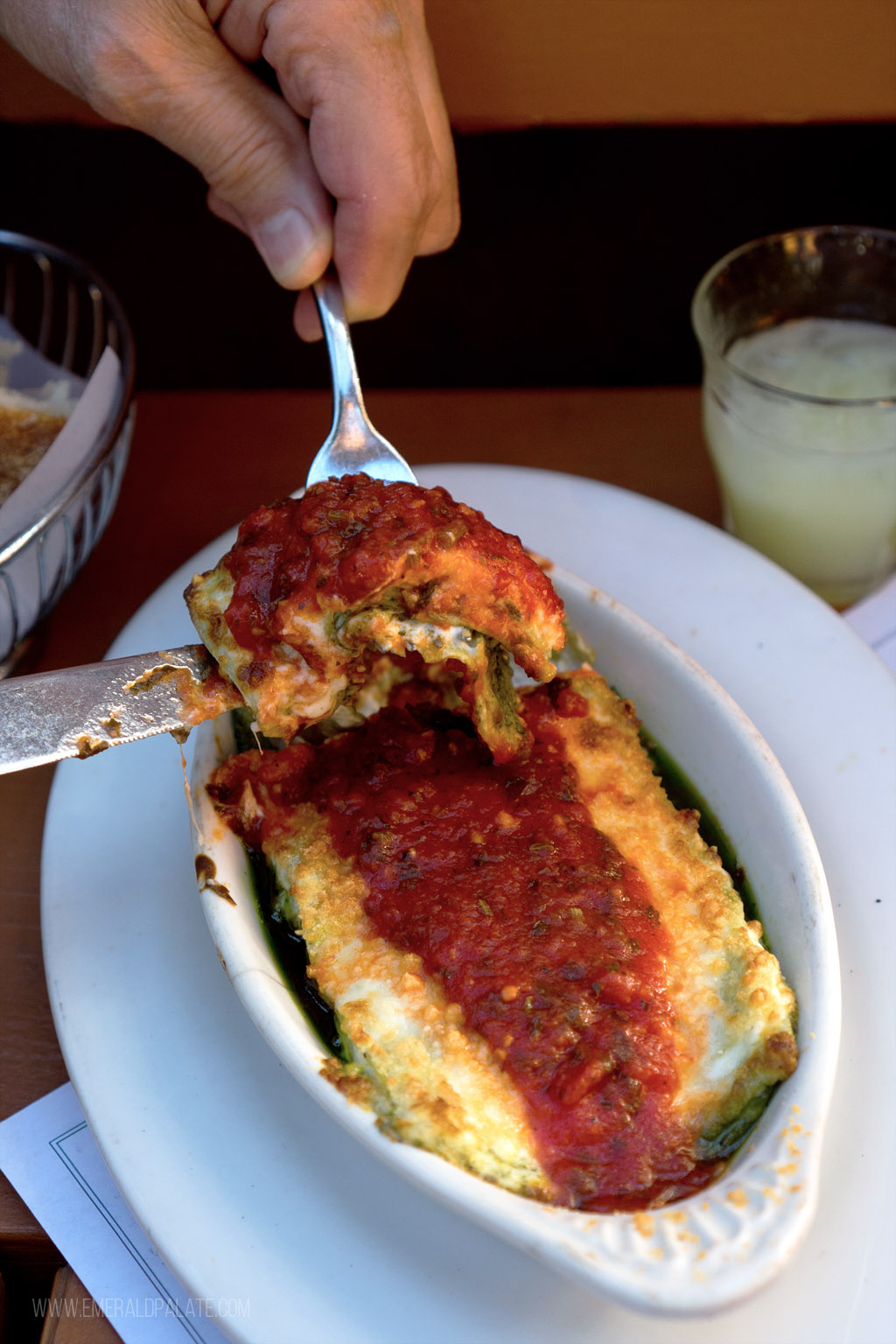 person picking up lasagna from a restaurant in Pike Place Market