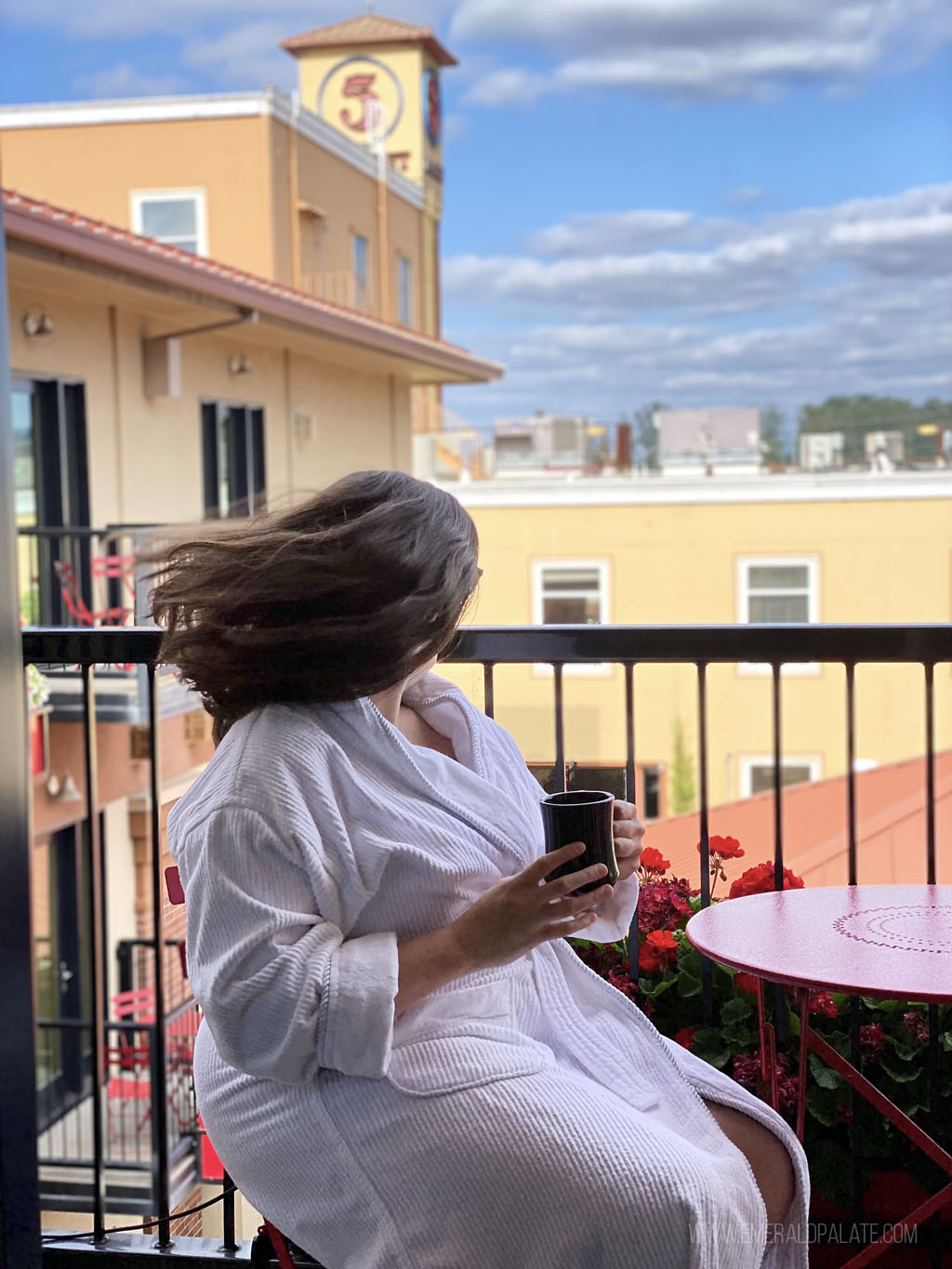 woman's hair blowing in the wind from a balcony in one of the best luxury hotels in Eugene, OR