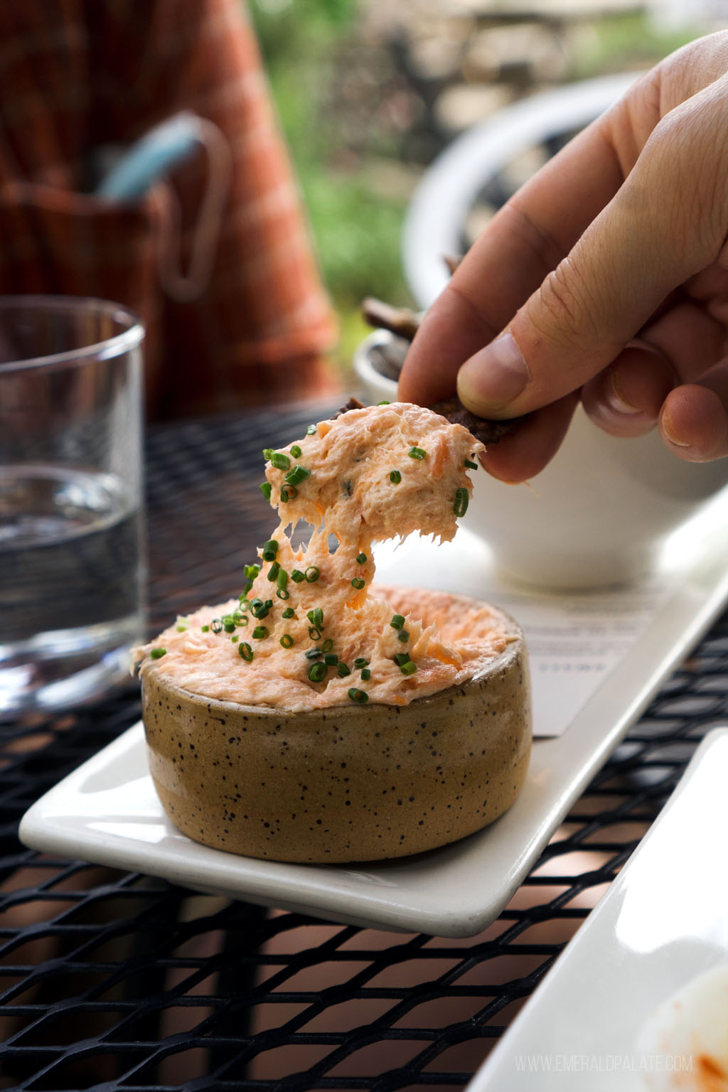 person dipping chip in salmon dip from a Port Townsend restaurant