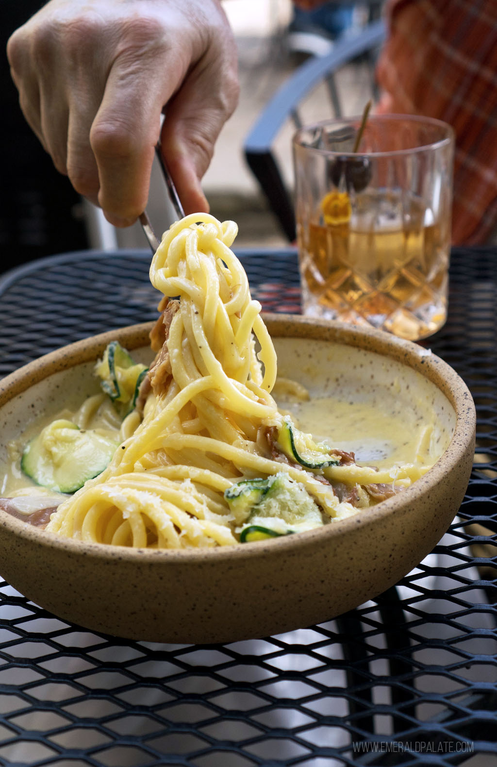 person picking up pasta from Finistere