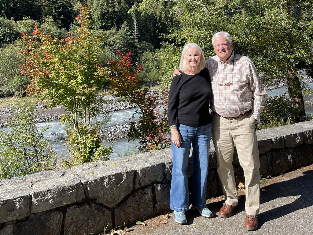 couple standing in front of river they visit on a custom trip itinerary
