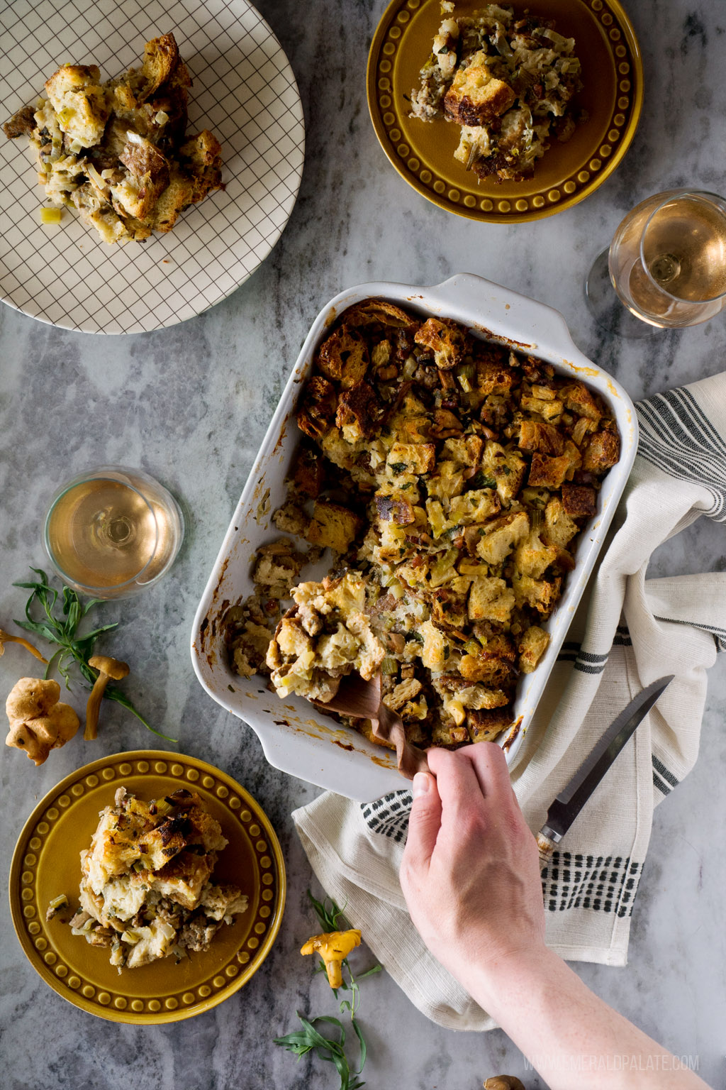 person spooning out portion of Thanksgiving stuffing