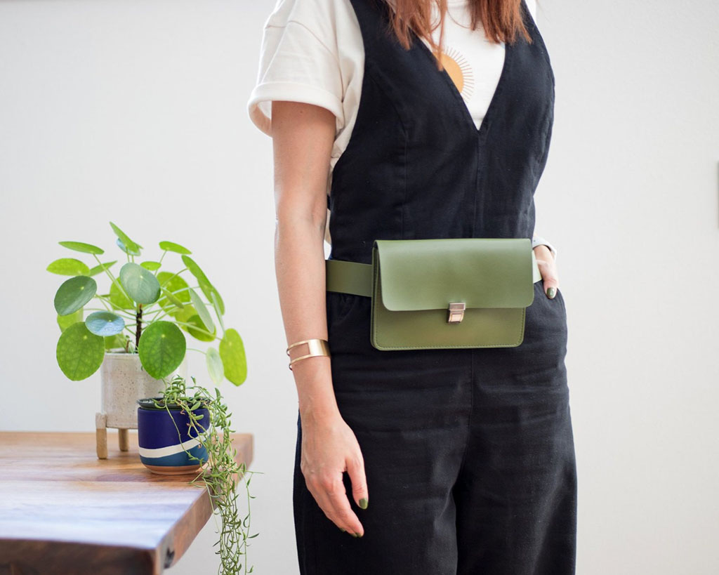 a modern green vegan leather fanny pack, one of the most unique gifts for travelers because it converts into a crossbody bag!