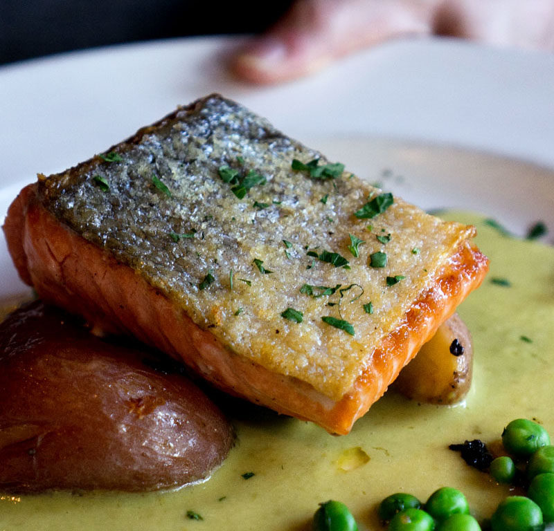 seared salmon over potatoes and peas from one of the best restaurants in Willamette Valley