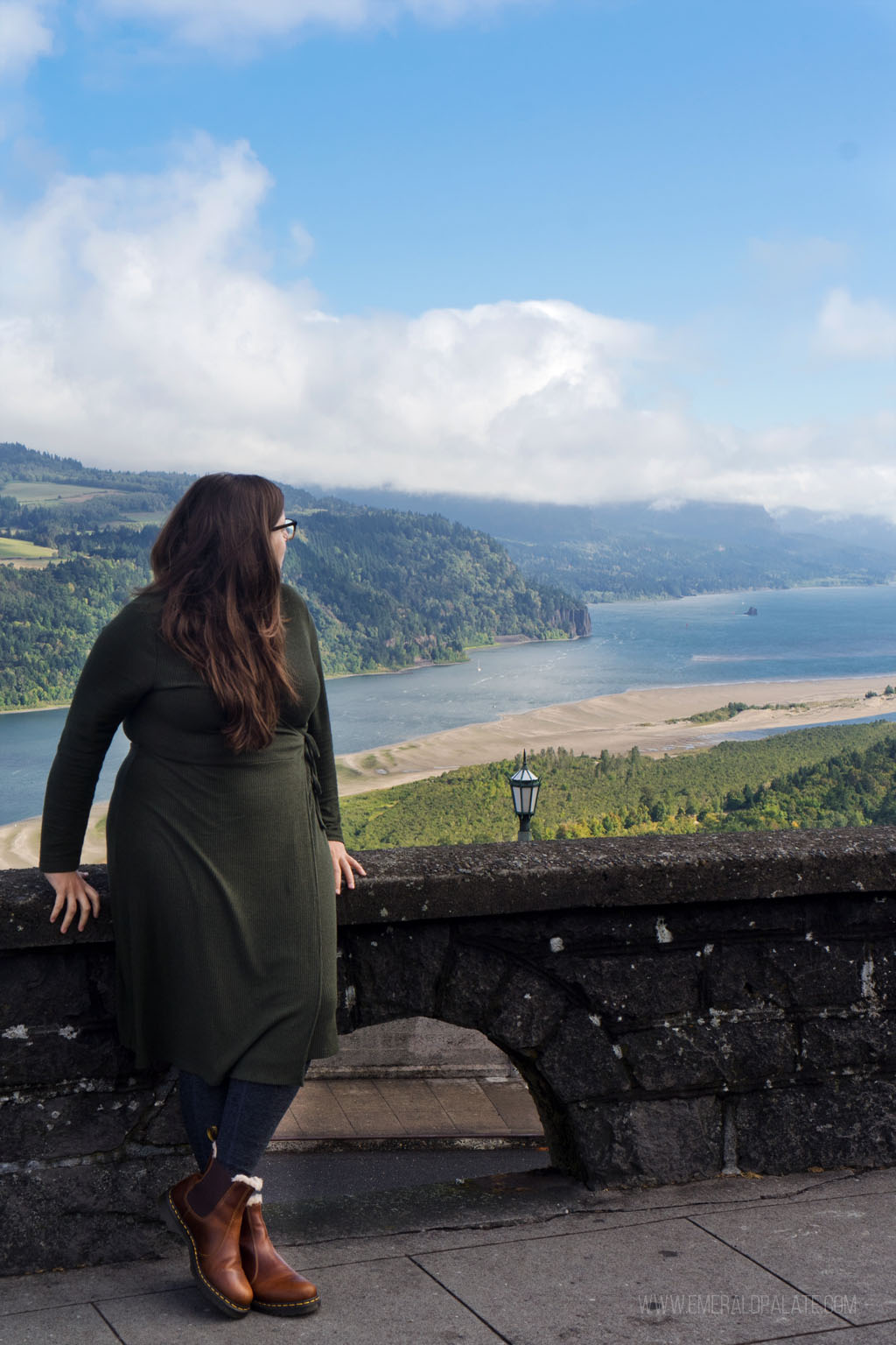 woman looking over her shoulder at a lookout at Columbia Gorge