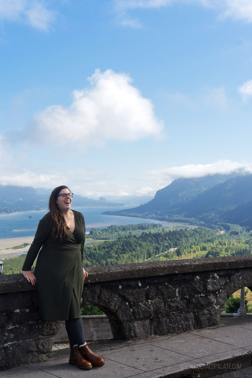 woman laughing at lookout visited during a Columbia River Gorge itinerary