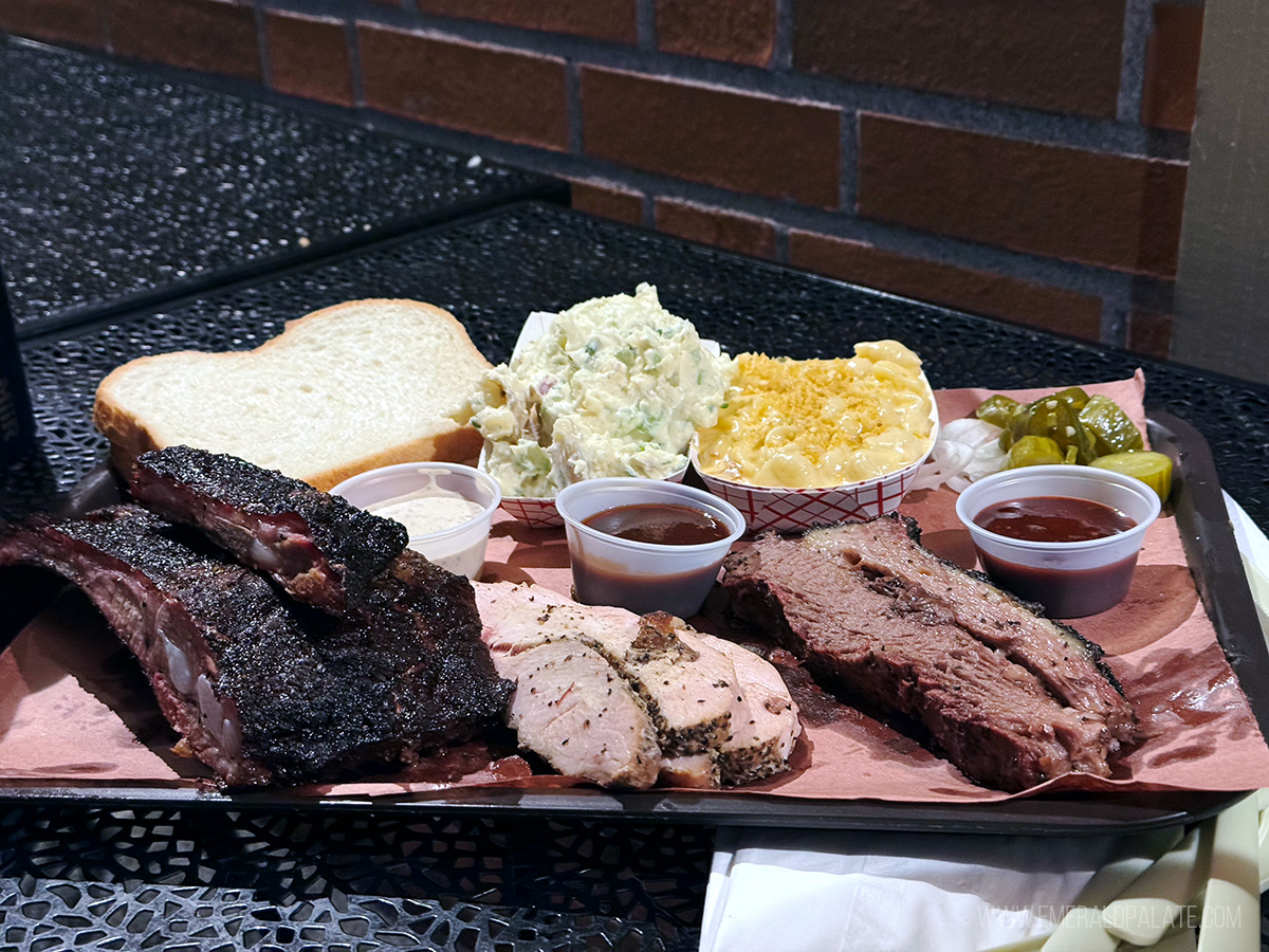 tray of BBQ meats like brisket, smoked turkey, and ribs along with mac and cheese and potato salad side from a PDX food truck