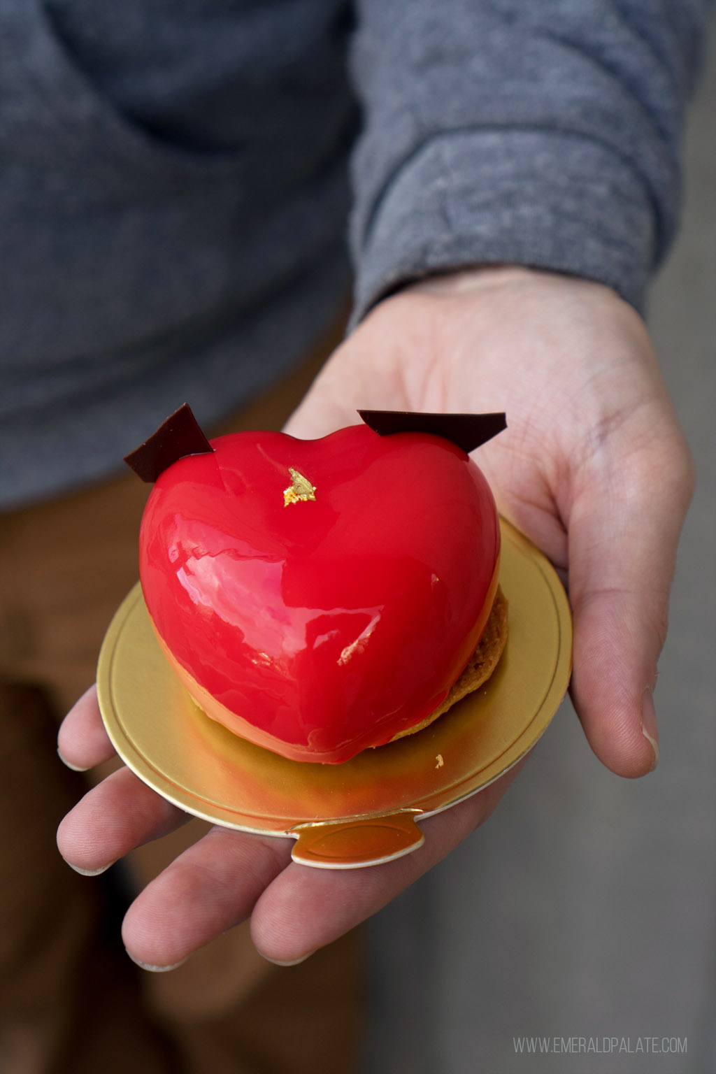person holding a heart-shaped pastry from PDX