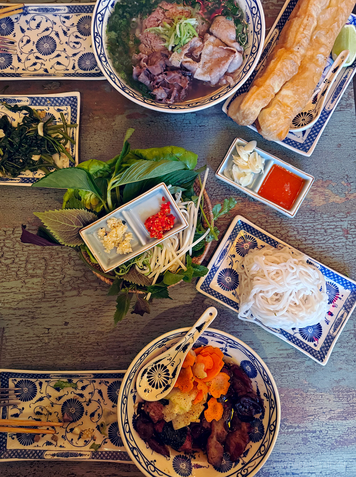 spread of Vietnamese food on a table at one of the most fun places to eat in Portland