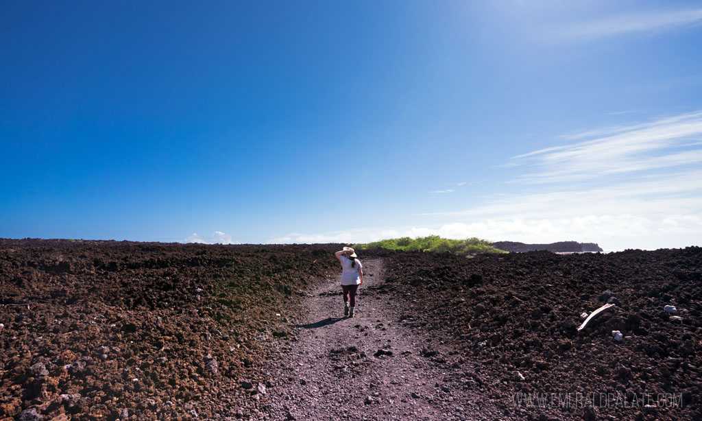 woman walking in lava fields in Maui