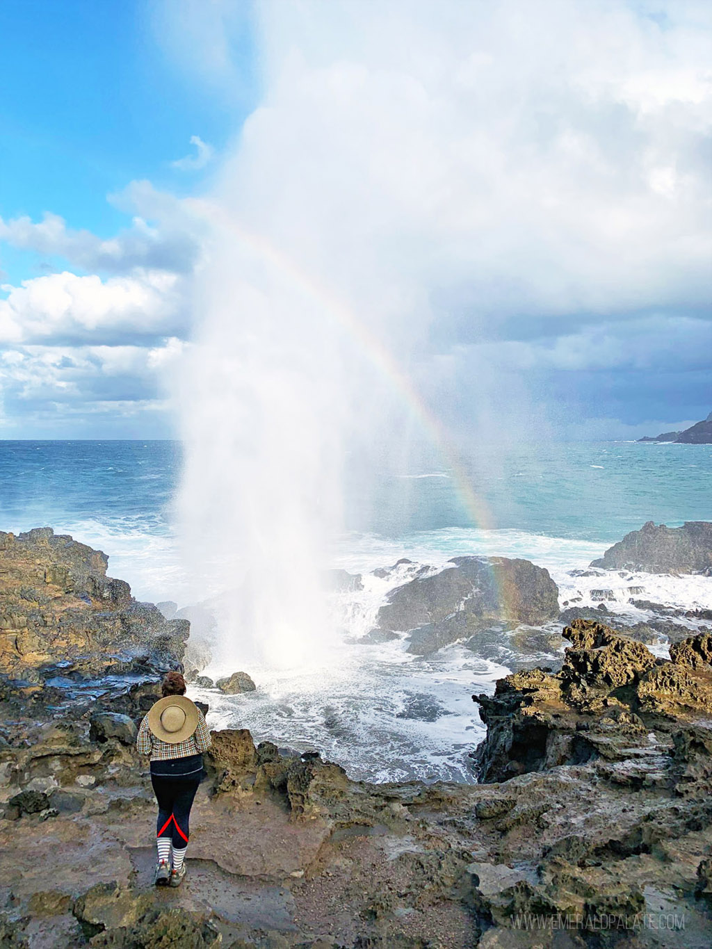 water shooting from a blowhole on one of the best hikes on Maui with a rainbow