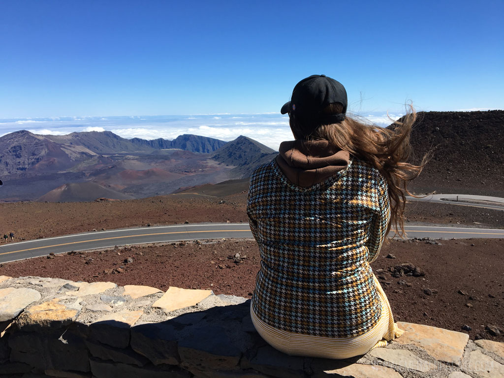 woman enjoying the view with wind in her hair on the top of Haleakala in Maui