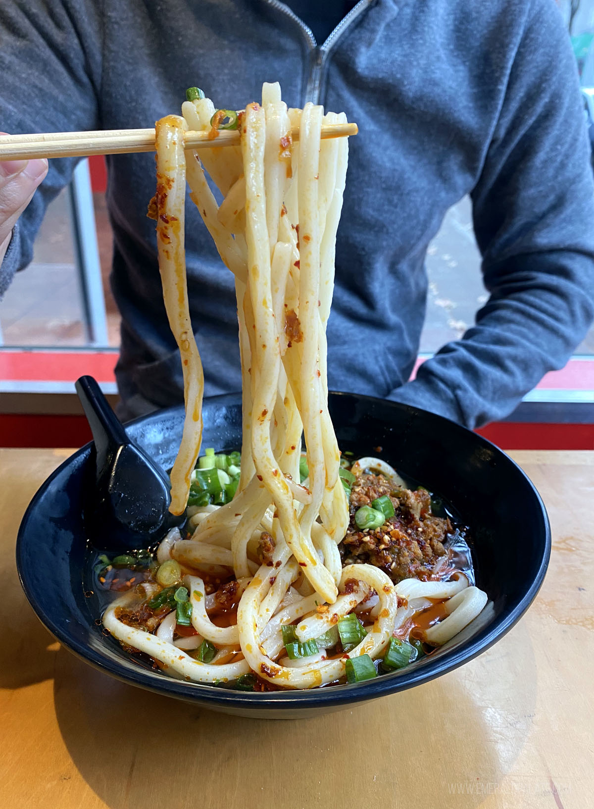 person picking up noodles from some of the best soup shops in Seattle