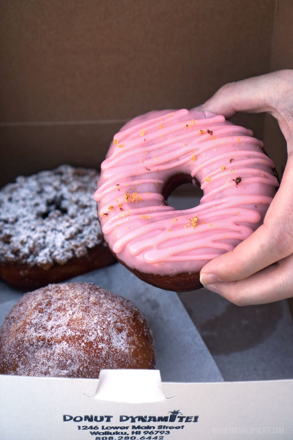 Where do the locals eat in Maui? All the places you cant miss 22 person holding frosted doughnut from Maui