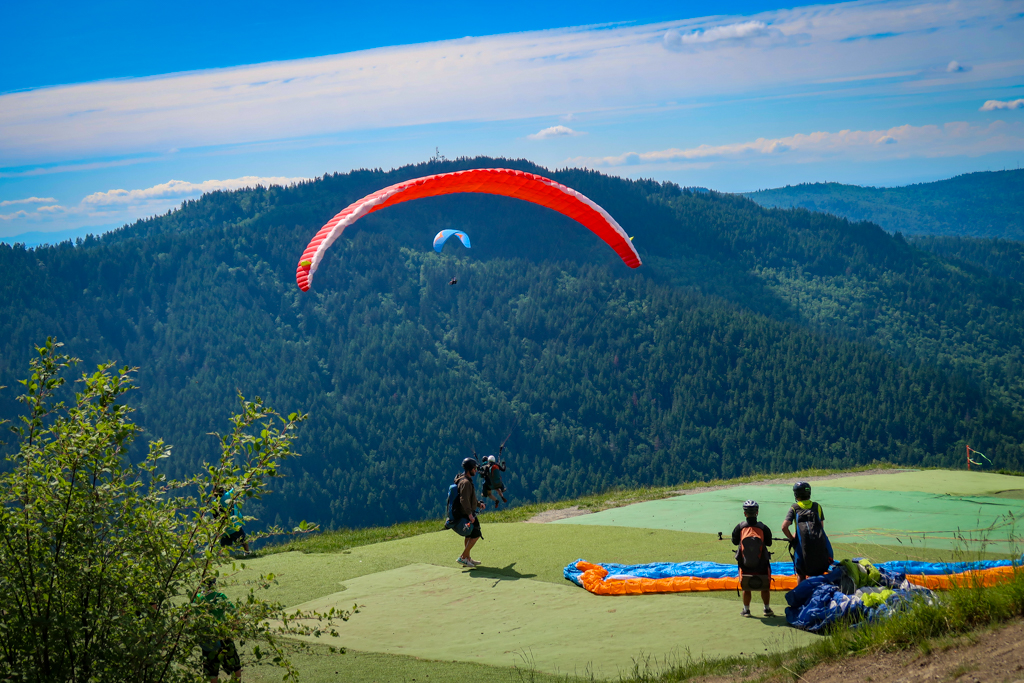 Person paragliding off Poo Poo Point, a top Seattle hike
