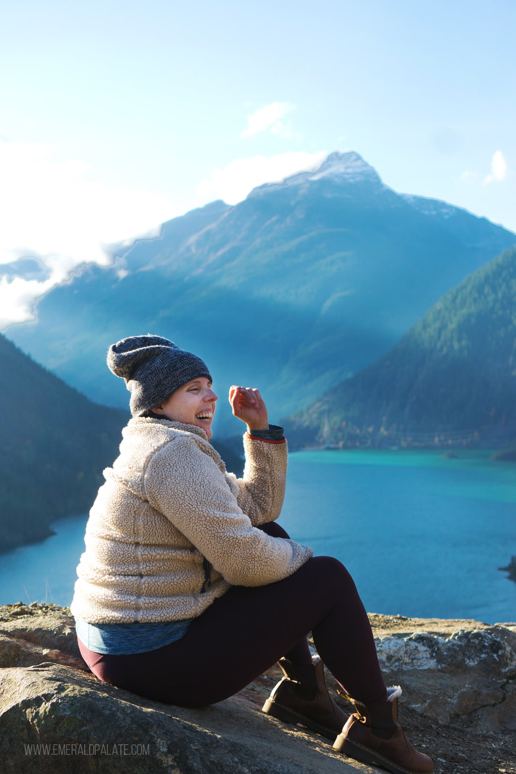 woman sitting on a ledge near Blue Lake, a must stop on your North Cascades National Park itinerary