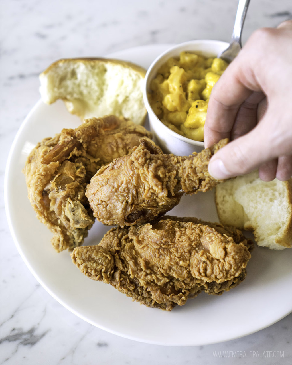 person picking up fried chicken from a restaurant that has some of the best fried chicken in Seattle