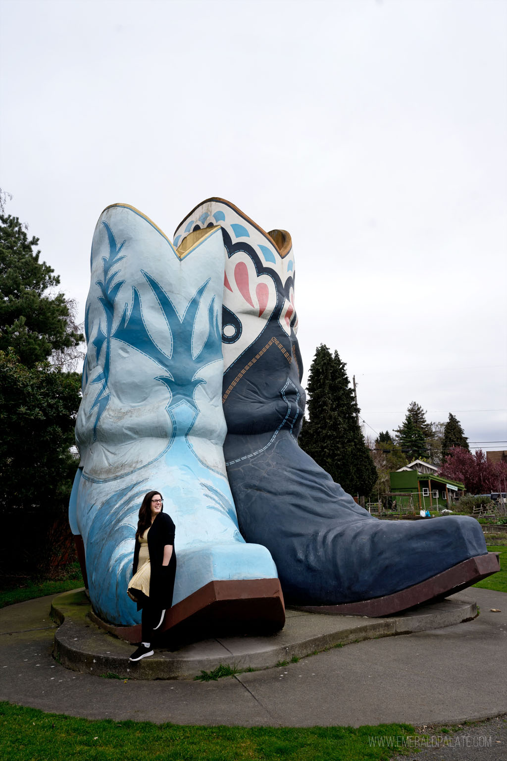 woman in front of big cowboy boots sculpture, a Seattle bucket list must do