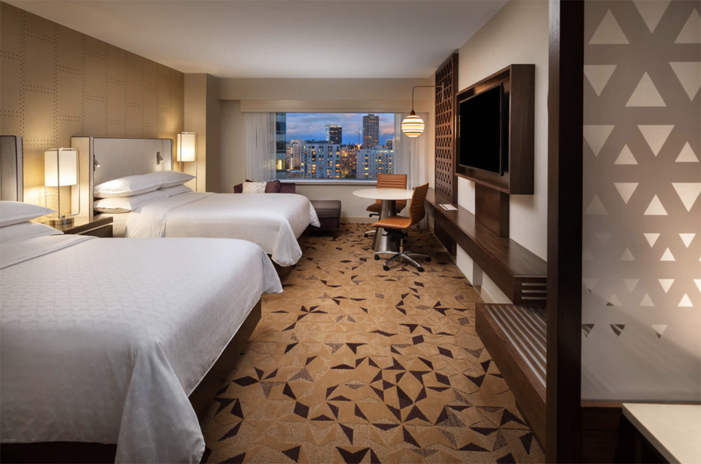 two king beds in a hotel room of one of the best eco-friendly hotels in Seattle