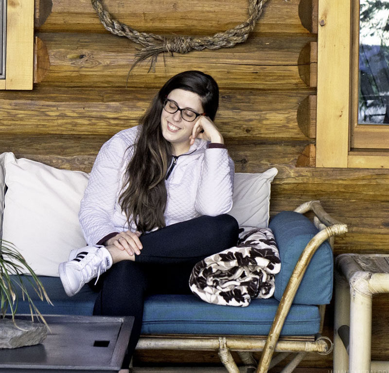 woman sitting outside one of the best Washington coast cabins