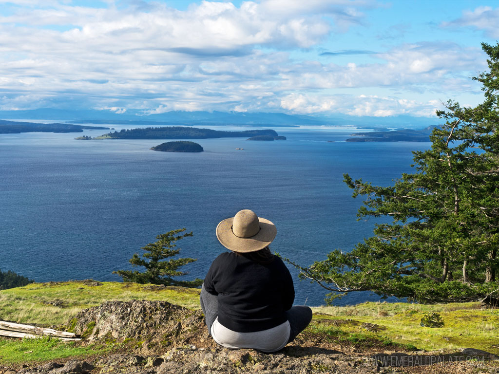 woman overlooking water on a peak during a day trip to Orcas Island from Seattle
