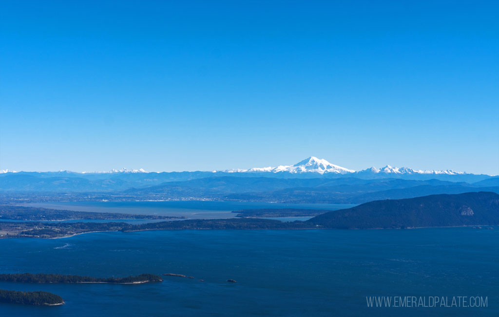 Snow capped mountain in the distance from a mountain view point on the San Juan Islands