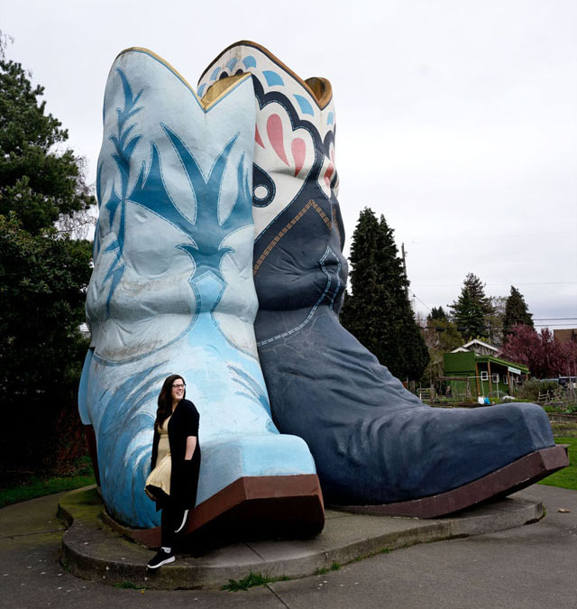 woman standing in front of big cowboy boot structure in a park in Georgetown