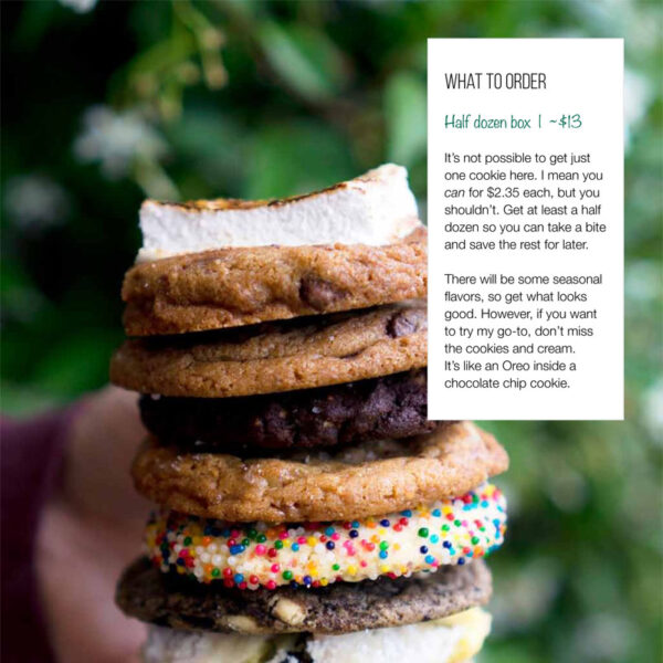 person holding a stack of cookies from a restaurant on The Emerald Palate's self-guided Seattle food tour of the Georgetown neighborhood