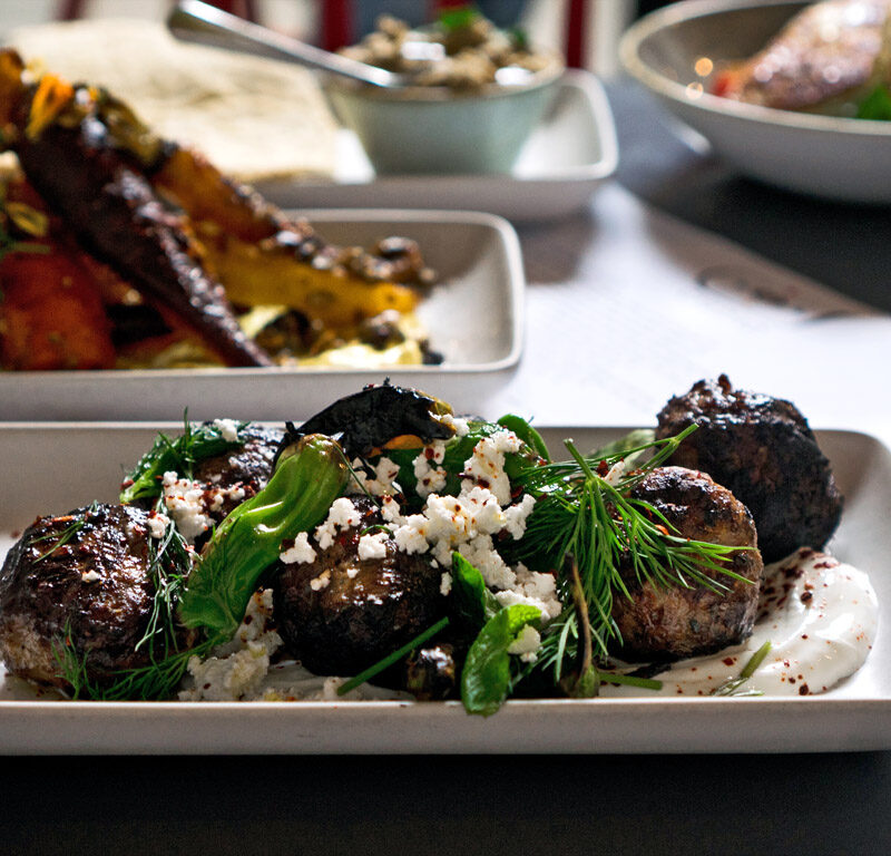 table filled with Mediterranean food in Seattle