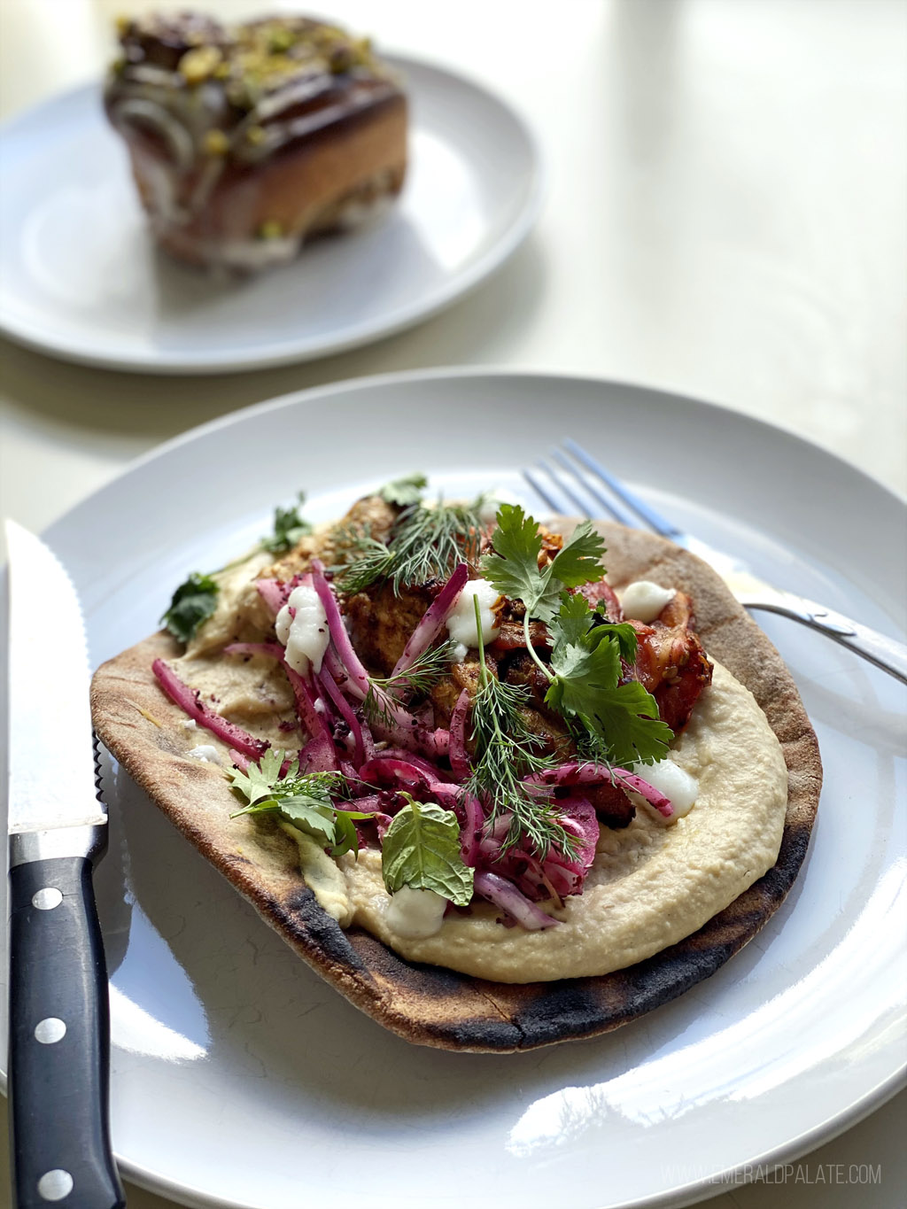 pita toast with hummus topped with dill and cabbage