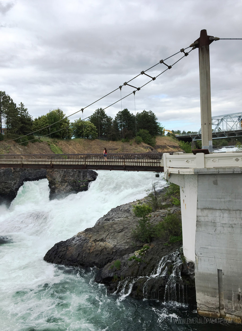 woman walking on bridge over Spokane Falls