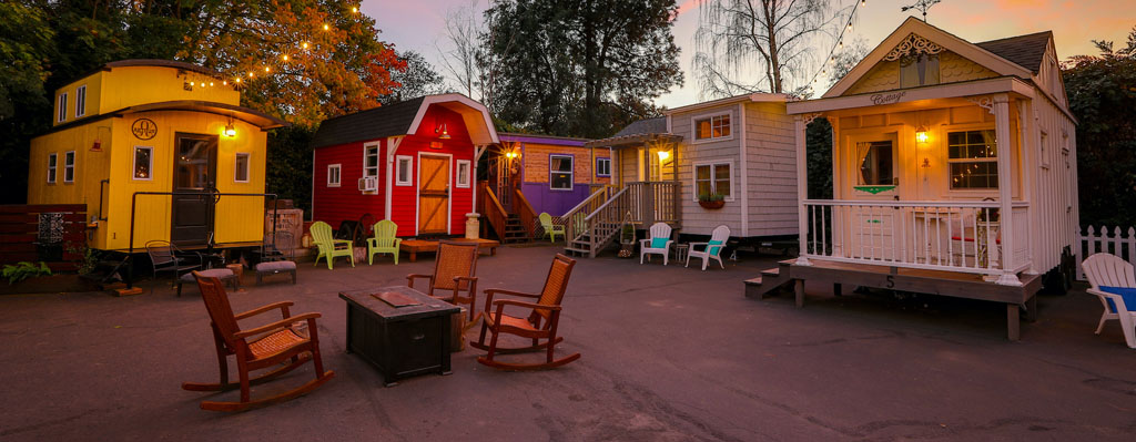 tiny homes surrounding a fire pit in a courtyard, a unique place to stay in Oregon