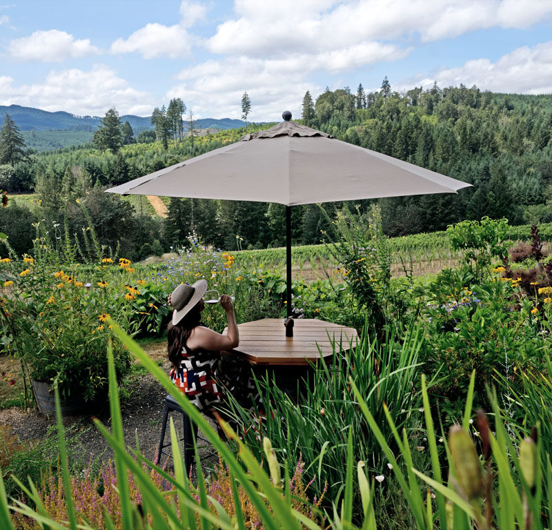 woman drinking wine in the garden of one of the best Eugene, OR wineries