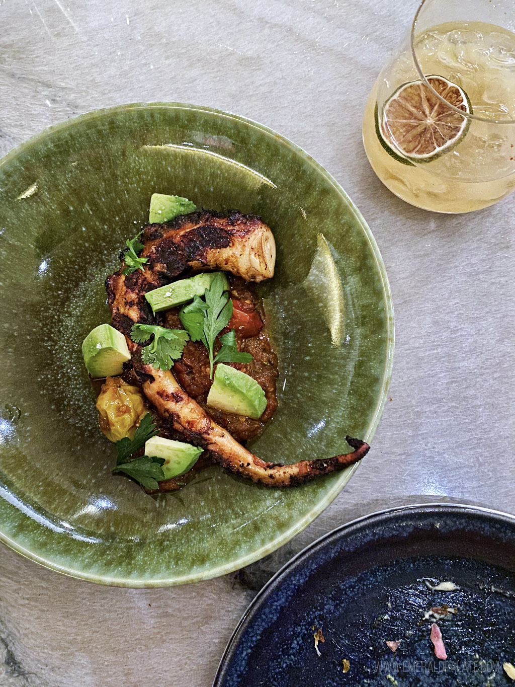 plate of octopus with tomatoes and avocado from one of the best places to eat in Portland, Oregon