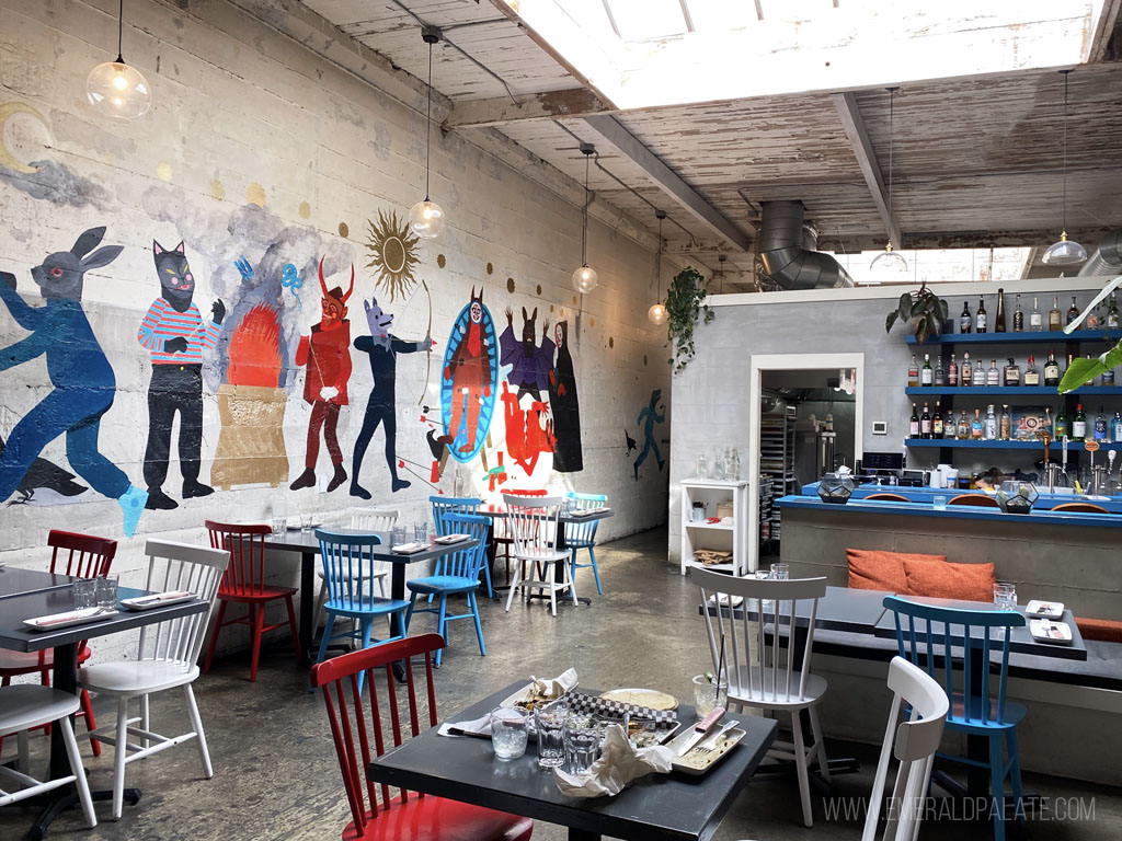 inside Ciudad, one of the cute restaurants in Seattle with a funky mural on the wall