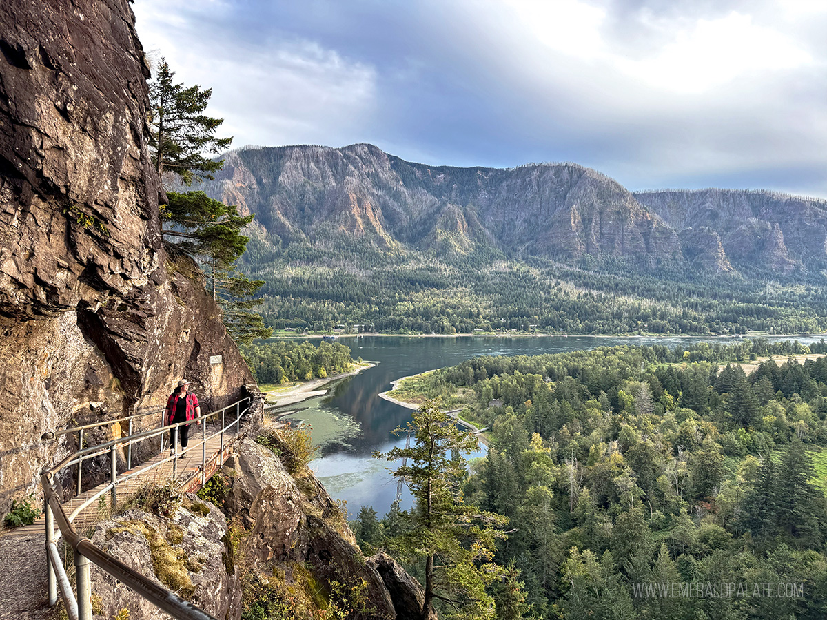 woman walking along a bath on a ridge overlooking Columbia River Gorge