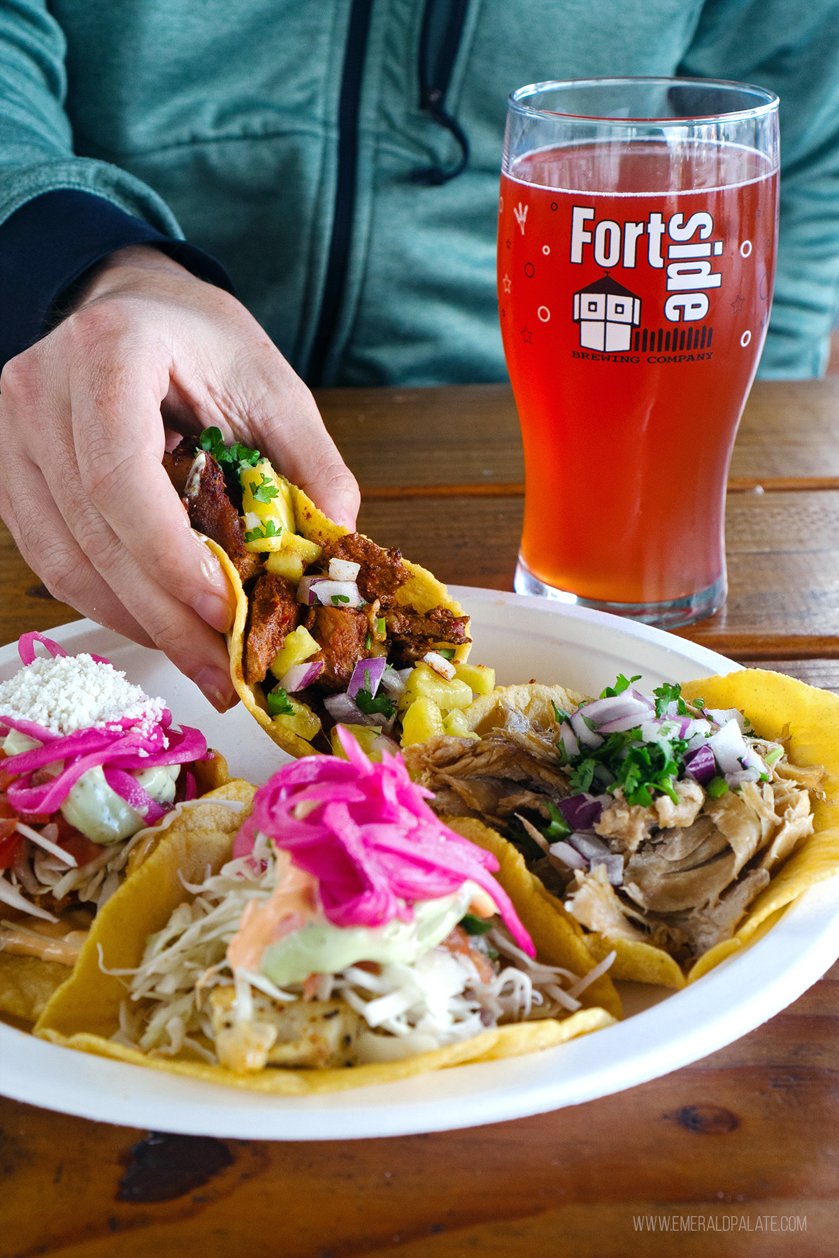 person picking up a taco at a brewery in Vancouver, WA