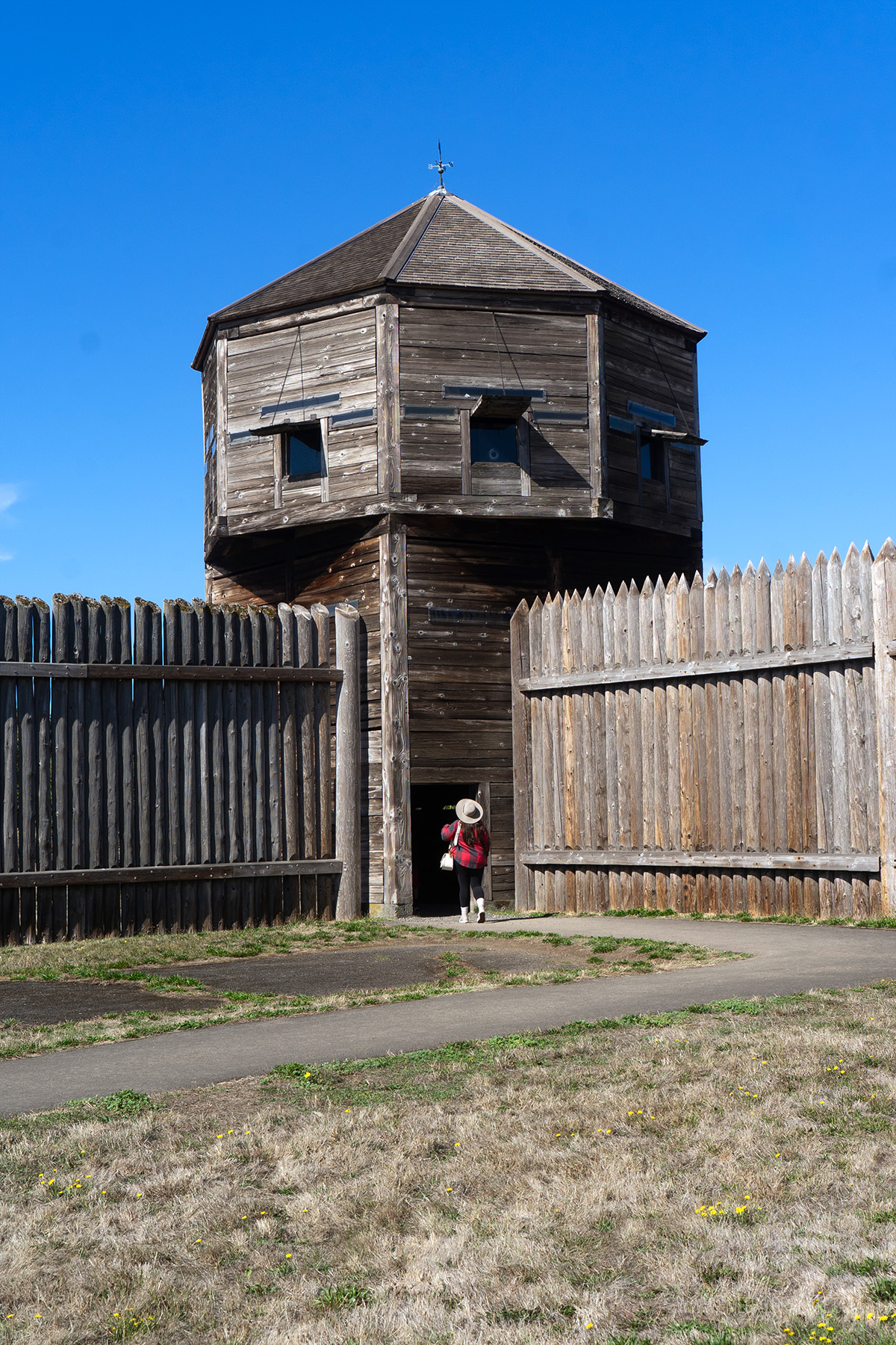 woman walking into a lookout tower at Fort Vancouver