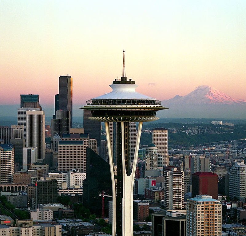 close up of the Space Needle at sunset with the skyline and Mt Rainier in the background, a must see on your Seattle 3-day itinerary