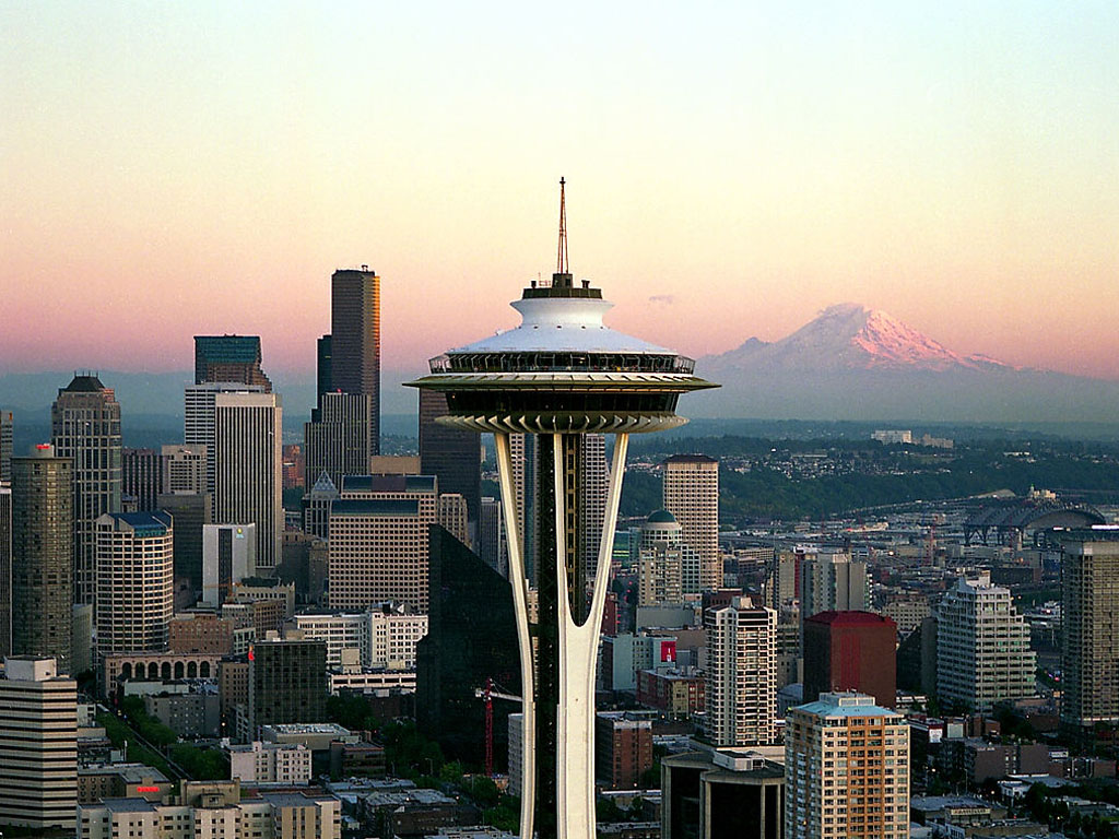 close up of the Space Needle at sunset with the skyline and Mt Rainier in the background, a must see on your Seattle 3-day itinerary