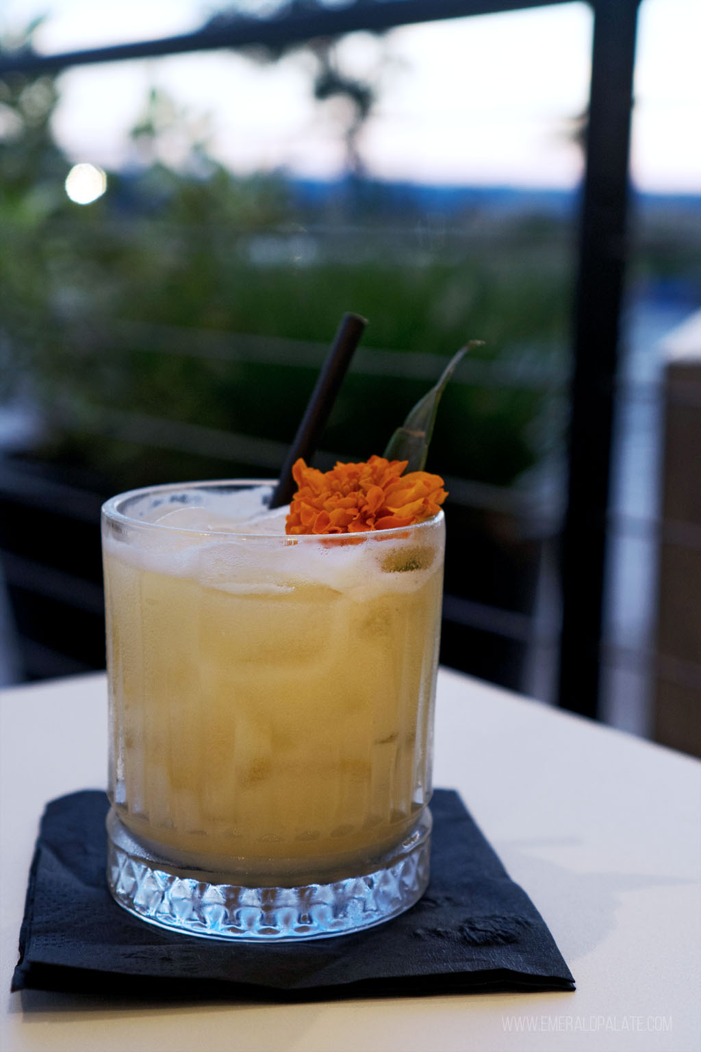 citrusy cocktail on a table outside at sunset