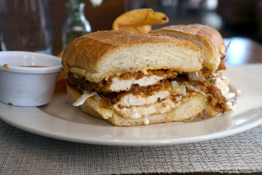 fried chicken sandwich on a plate with fries