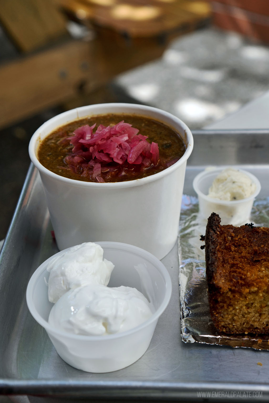 cup of chili with sour cream, butter, and cornbread from a Vancouver, WA restaurant