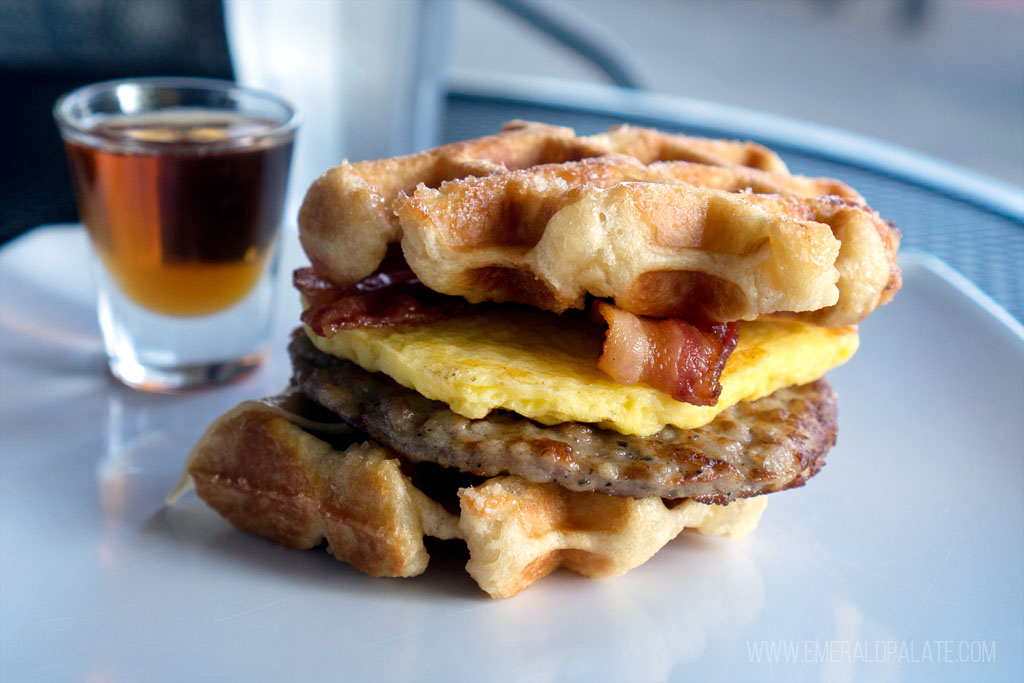waffle sandwich with sausage, egg, cheese, and bacon