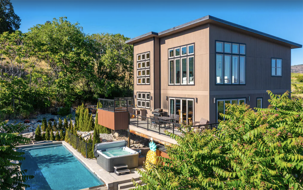 exterior of a modern two-story Lake Chelan vacation rental with a private pool and hot tub